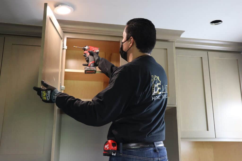 Handyman working on Cabinet Door Repair